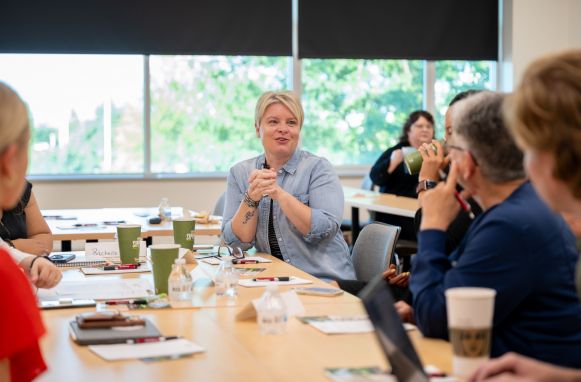 People around a conference table one person in focus