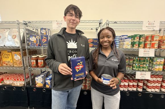 Waubonsee student workers John Metych (Left) and Germaine Mwizera (Right) stock the shelves ahead of the fall semester.