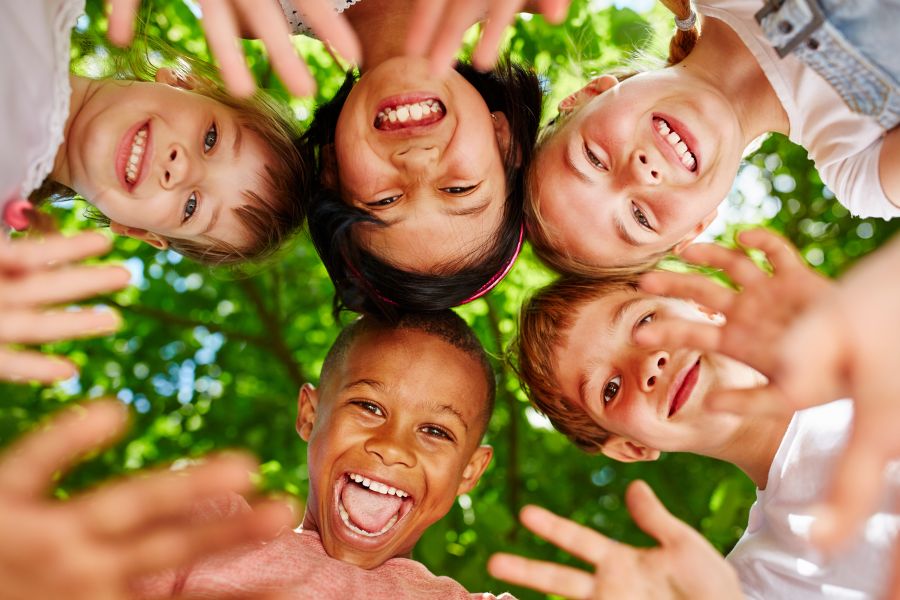 Group of kids in circle waving