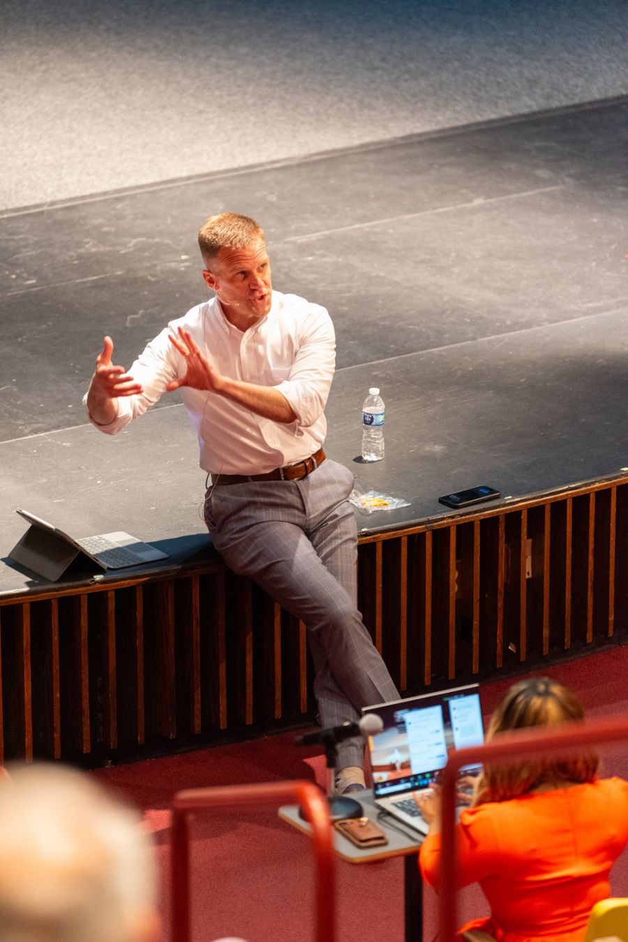 Dr. Knetl speaking on stage in front of audience