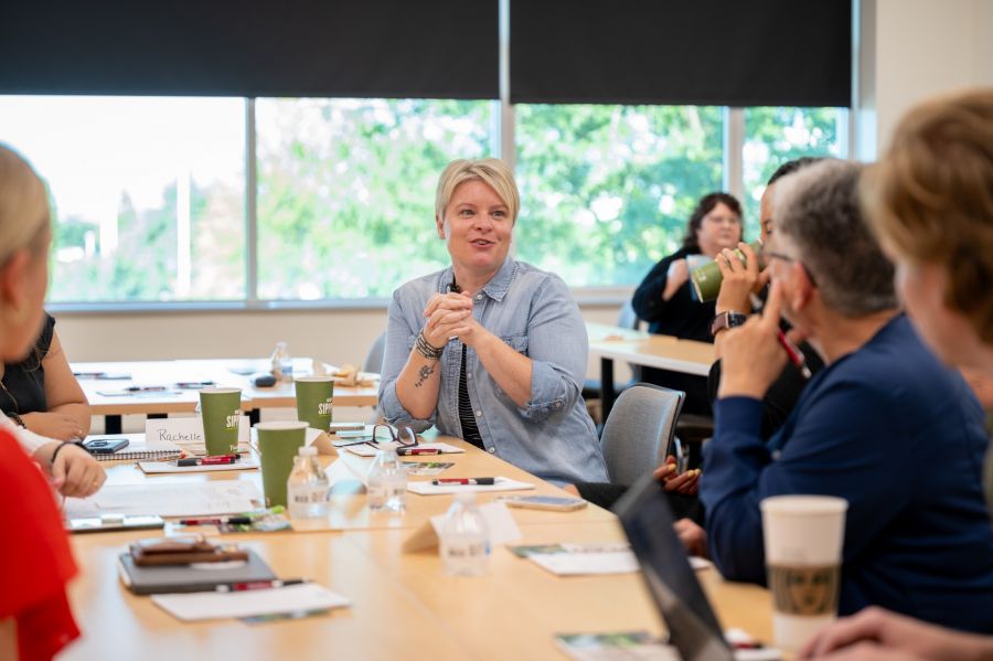 People around a conference table one person in focus
