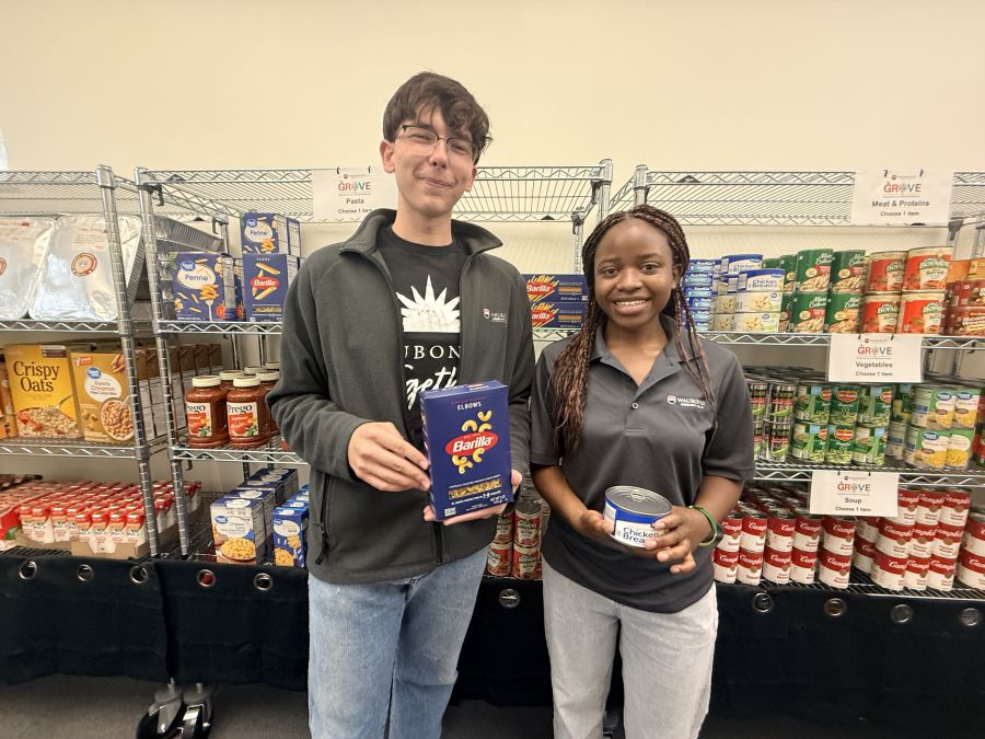 Waubonsee student workers John Metych (Left) and Germaine Mwizera (Right) stock the shelves ahead of the fall semester.